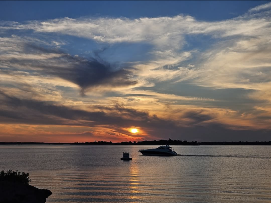 Sunset over Lake Texoma with boats on the water, featured image for Paradise Wellness Retreat.