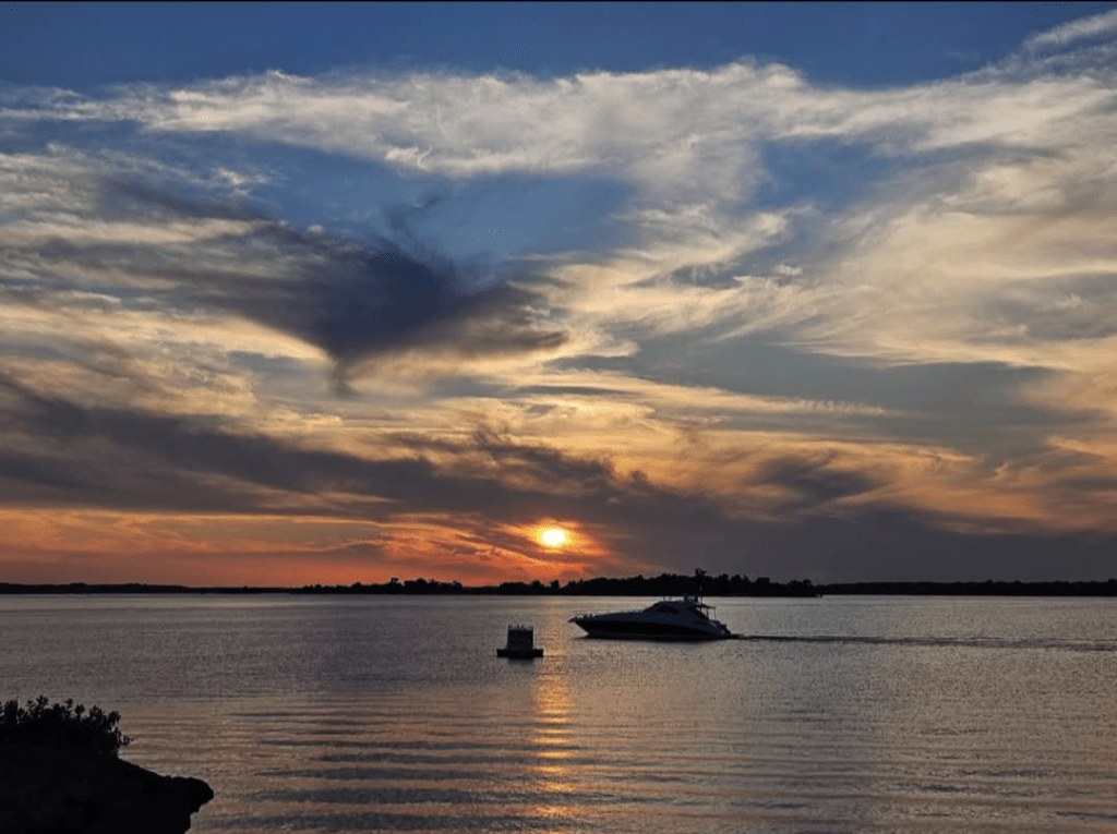 Sunset over Lake Texoma with boats on the water, featured image for Paradise Wellness Retreat.